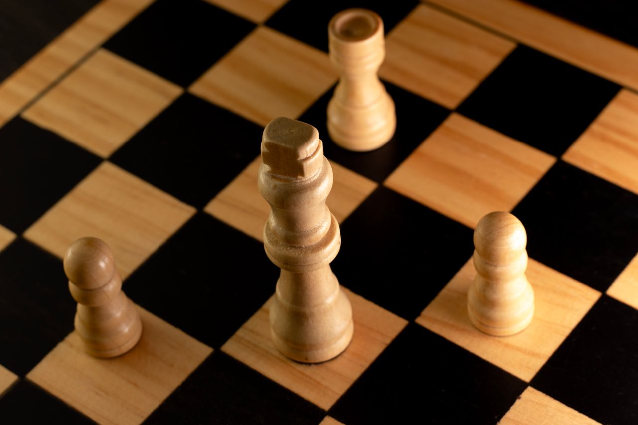 Services Wooden chess pieces arranged on a chessboard showcasing a classic strategy game scene.
